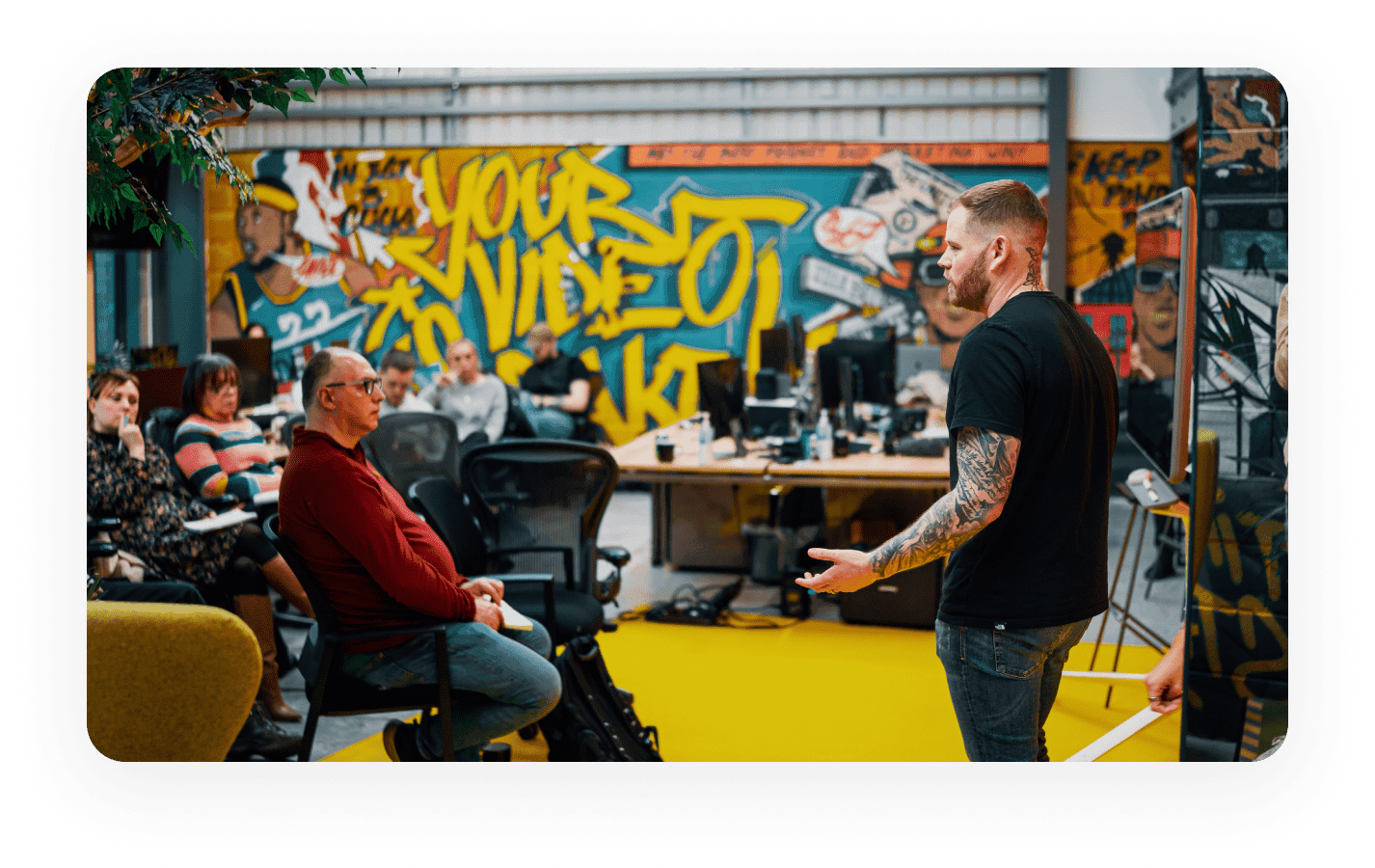 Jamie Garside leading a team meeting at the Viddyoze office